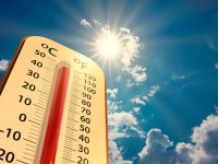 climate change, low angle view Thermometer on blue sky with sun shining in summer show increase temperature, concept global warming